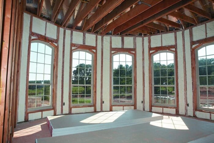 foam insulation filling spaces between wall studs and windows